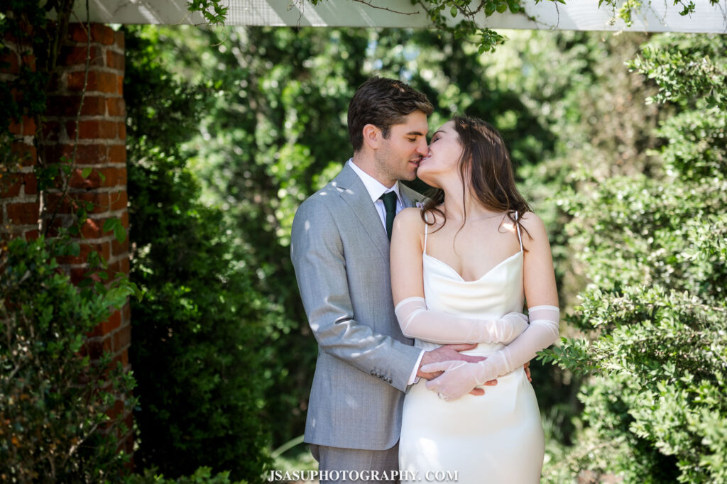 bride and groom posing for photo in garden at River Farm in Virginia