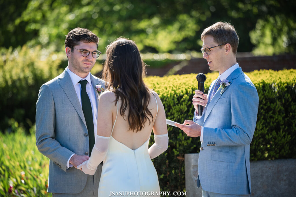 officiant speaking to bride and groom