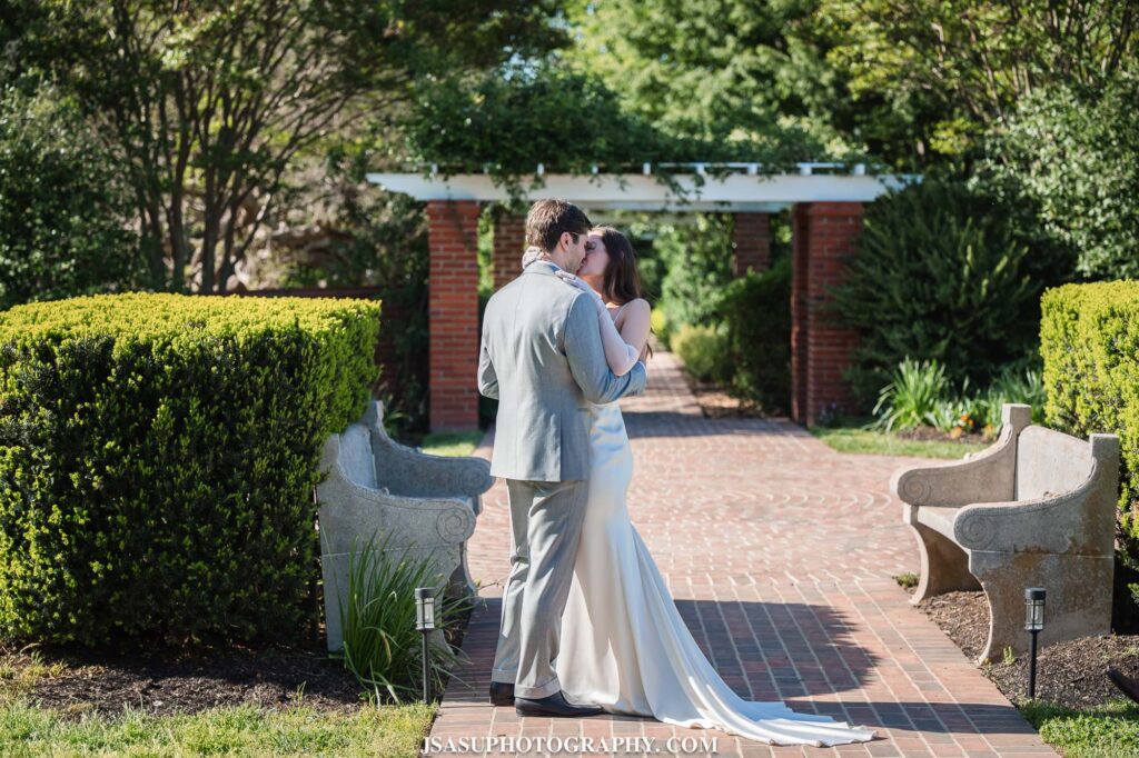 bride and groom kissing during wedding ceremony at River Farm in Virginia