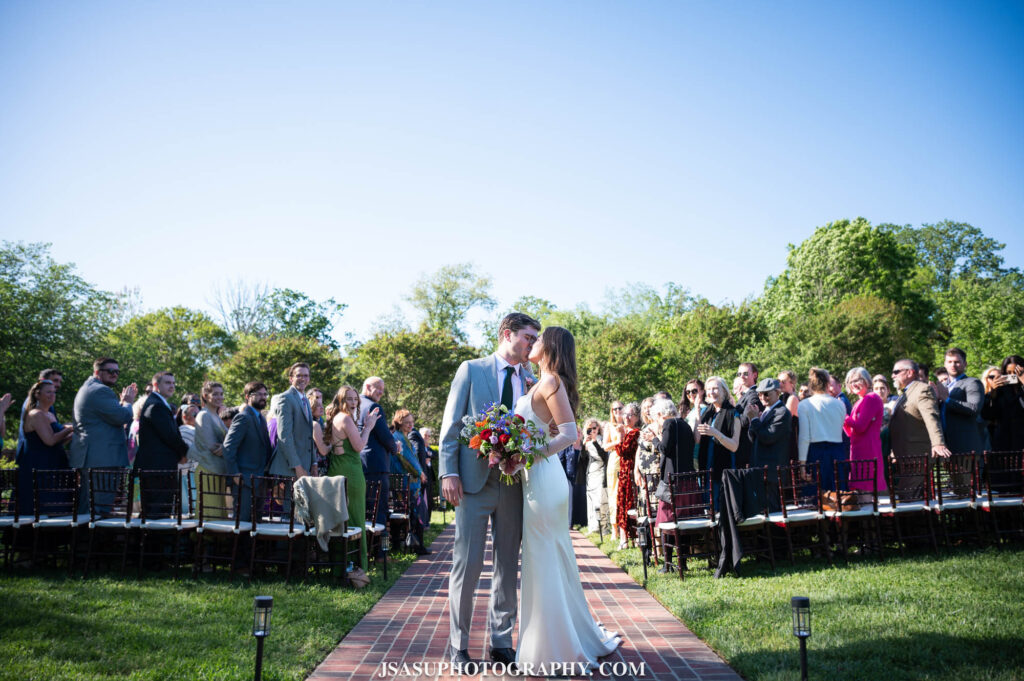 bride and groom kissing as they exit ceremony