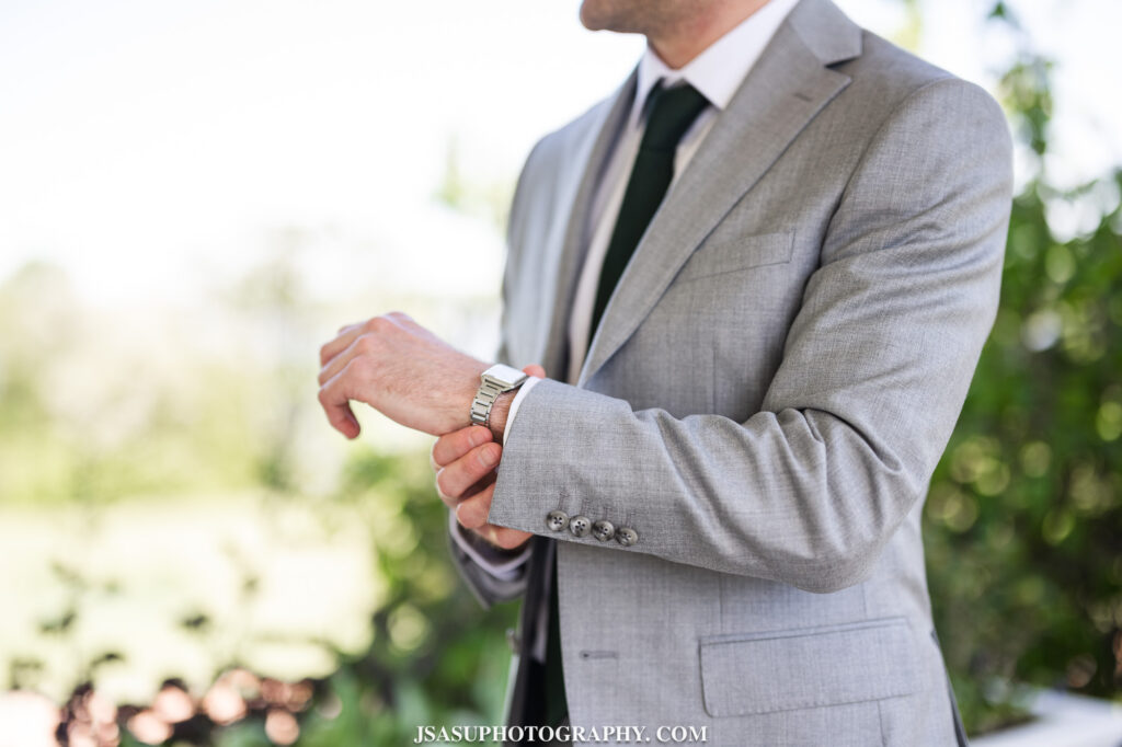 groom putting on watch 