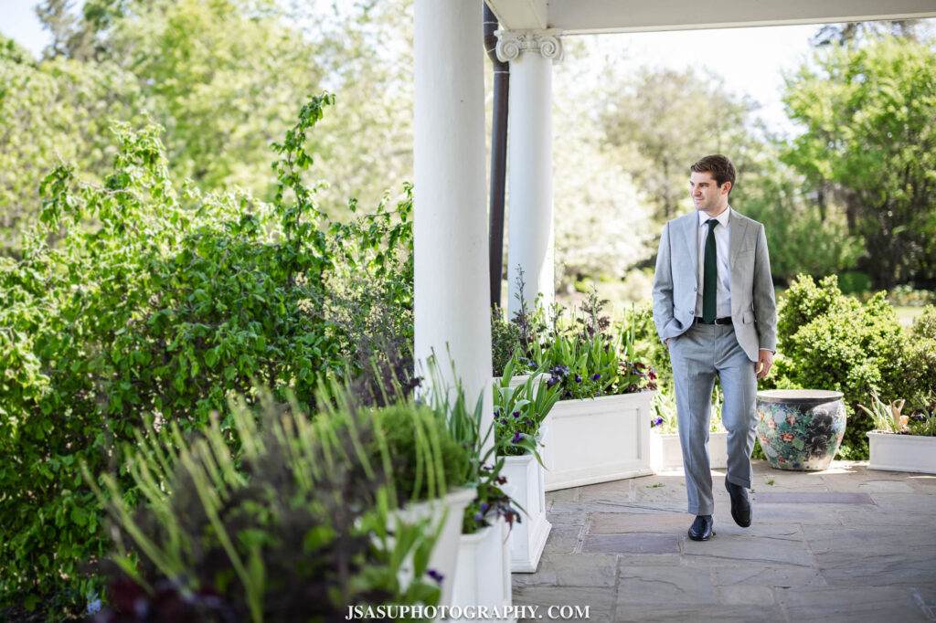 groom walking on porch at River Farm mansion