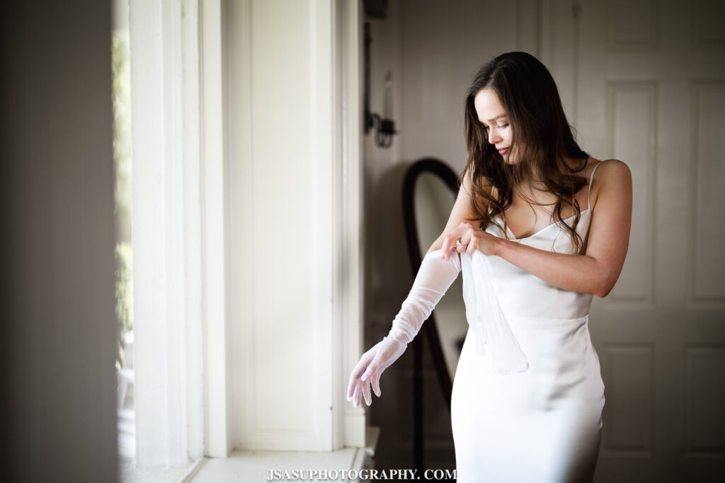 bride putting dress on at River Farm Mansion