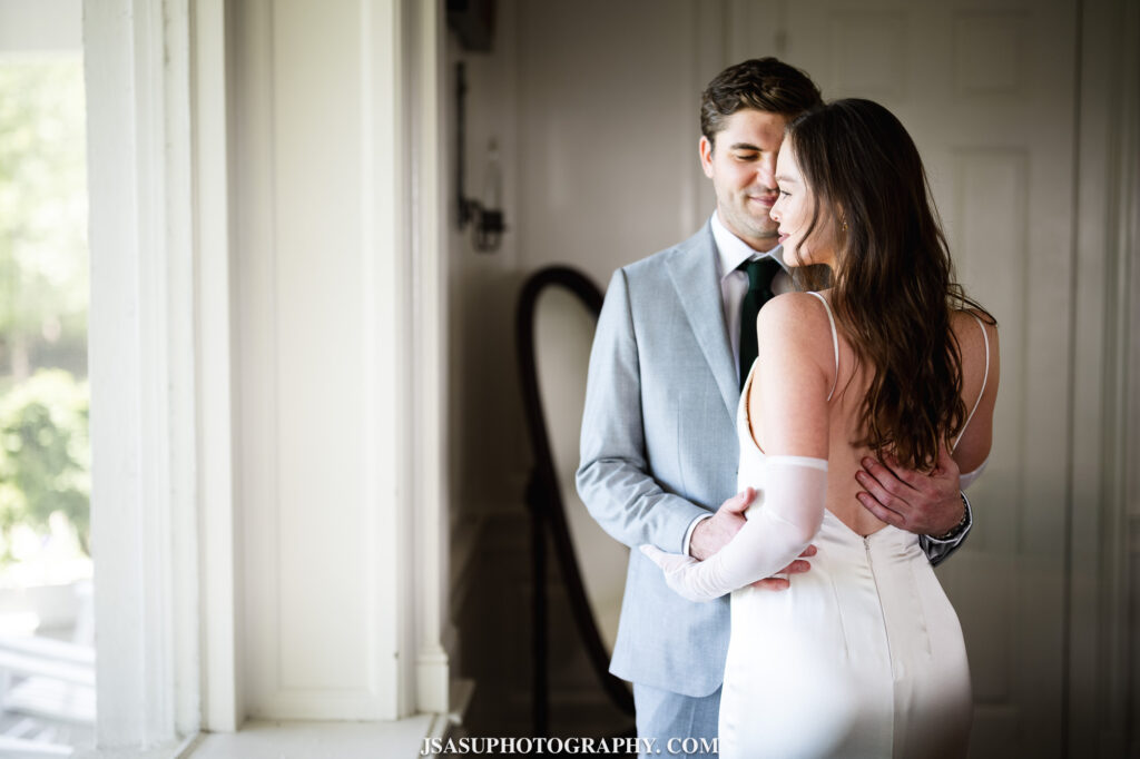 couple posing for portrait near window at River Farm Mansion