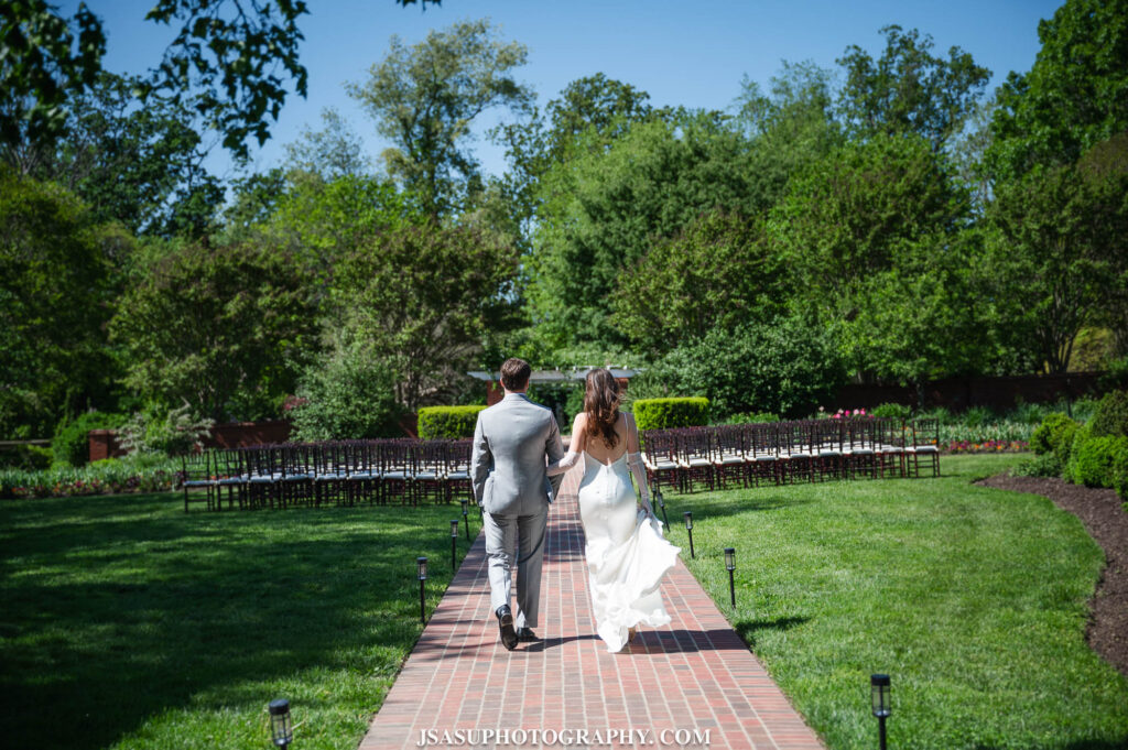 bride and groom walking through ceremony space at River Farm in Virginia