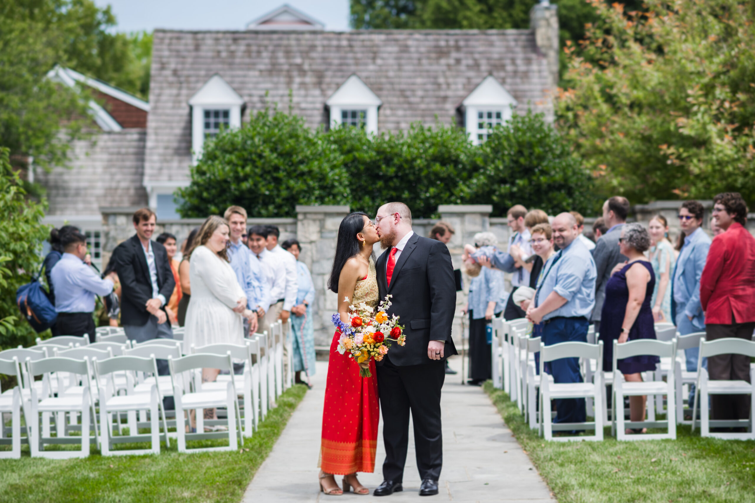 ceremony at kentlands mansion. kissing bride and group