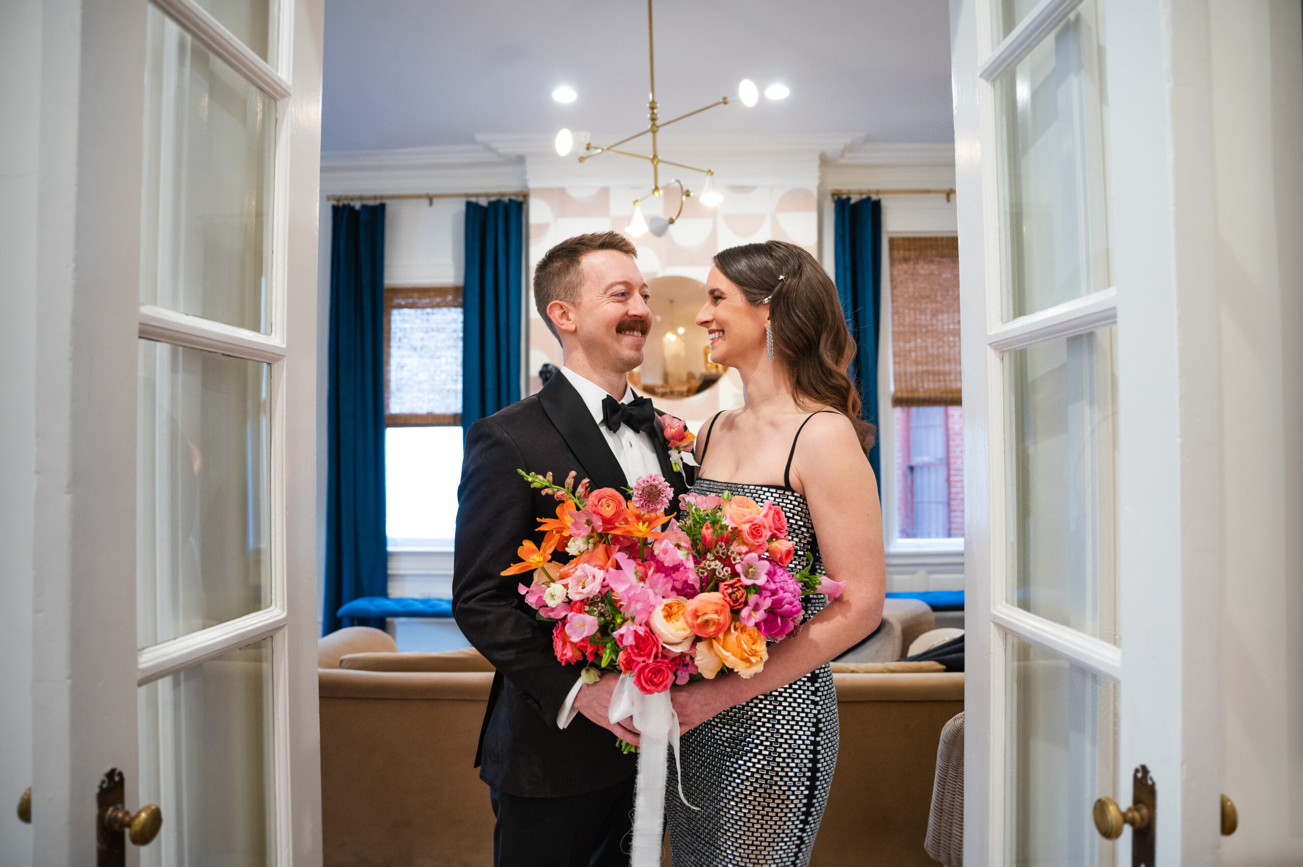 swann house wedding couple posing with flowers