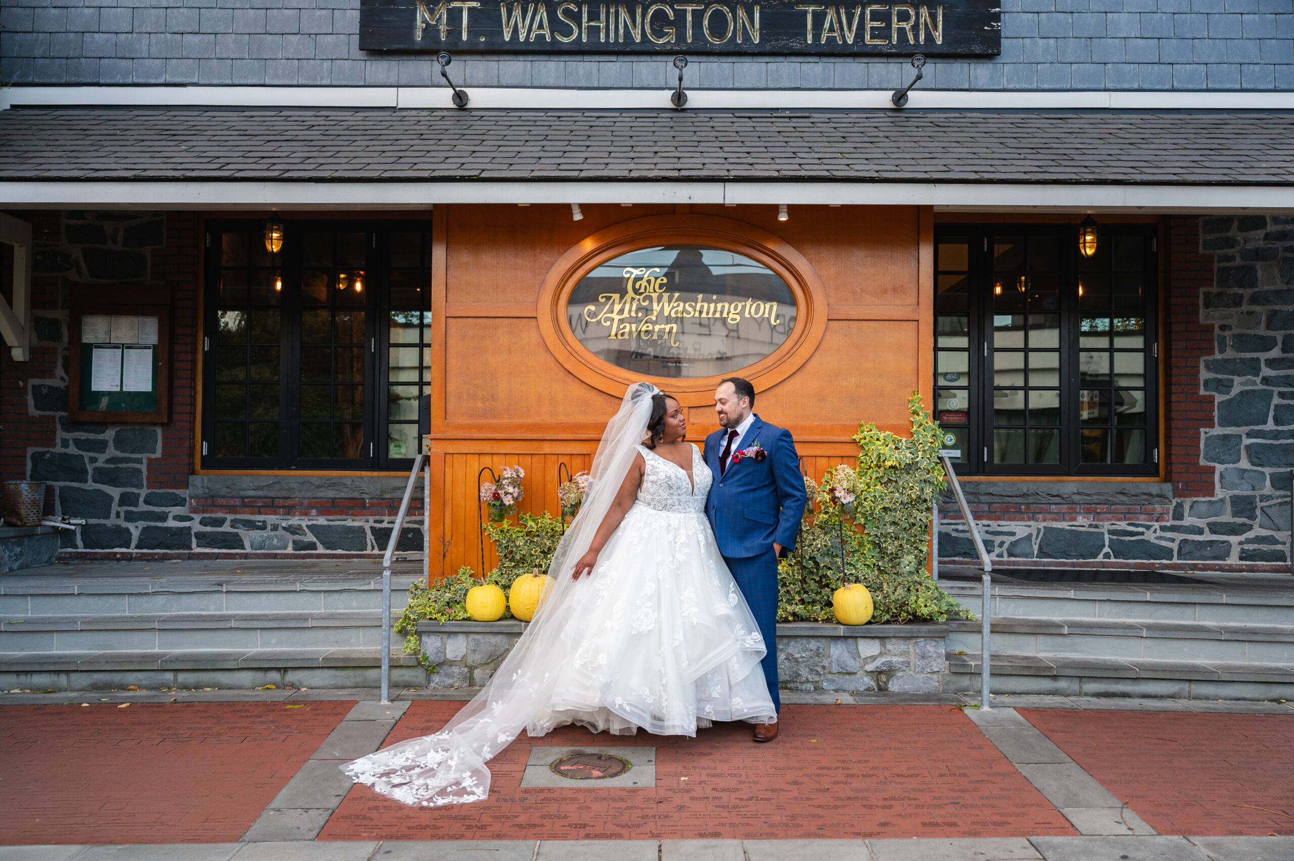 bride and groom in front of mt washington tavern