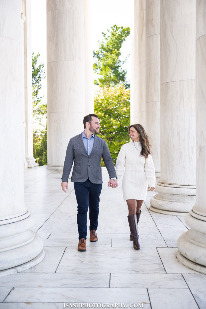 a couple walks along the tidal basin in washington, dc during their engagement session