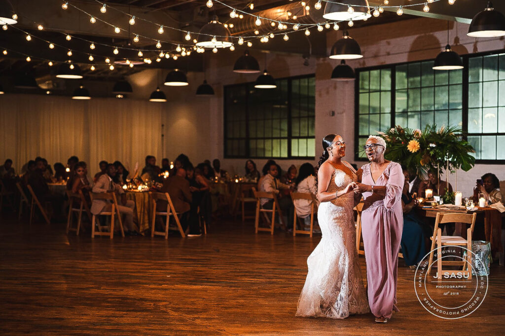 bride and mom share a dance on wedding night