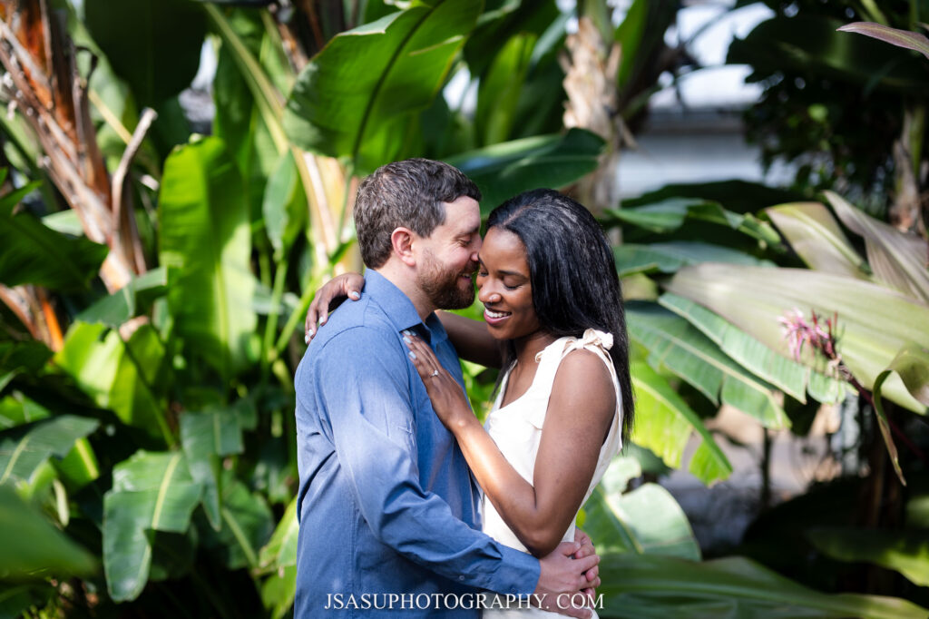 a couple poses for a photo at Rawlings Conservatory in Baltimore, MD 