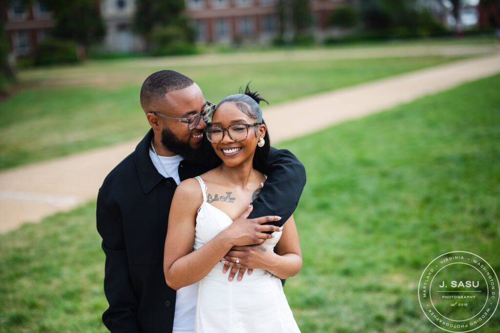 A couple smiles during their engagement photos on the quad at Howard University in Washington, DC