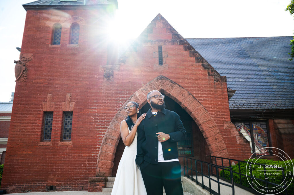 a couple poses for photos in their engagement session at Rankin Chapel at Howard University