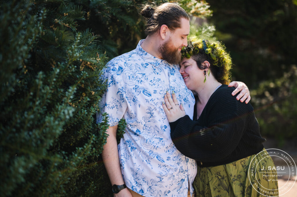 A couple stops for a photo in the Moongate Garden in Washington, DC during their engagement session. 